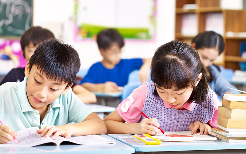 Students studying in a classroom at TLS Academy Singapore.
